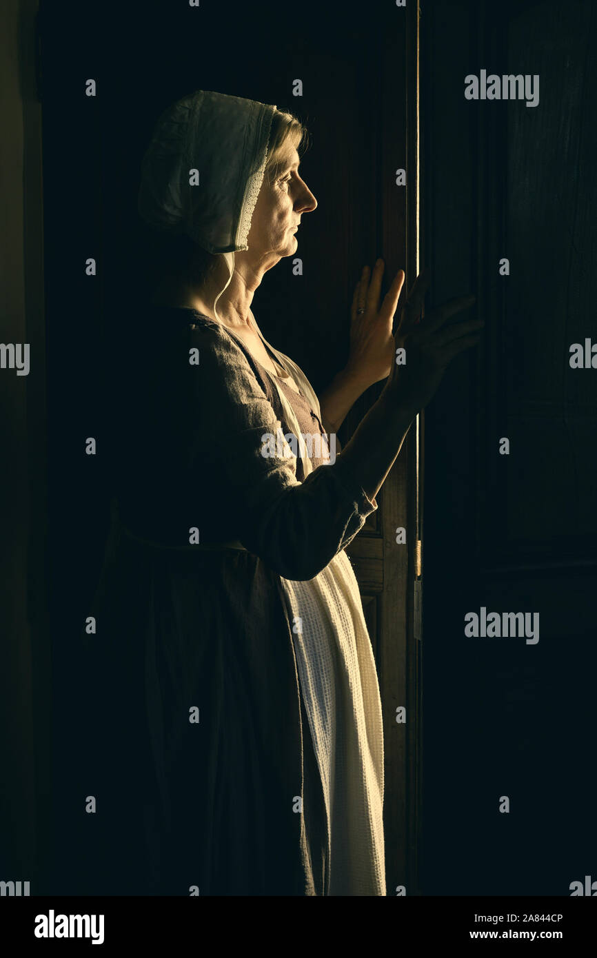 Woman listening at the door Stock Photo