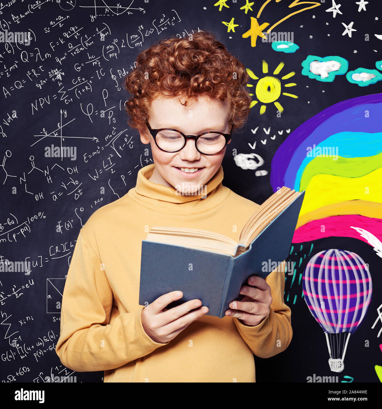 Imagination and creativity concept. Kid reading a book on fantasy background Stock Photo