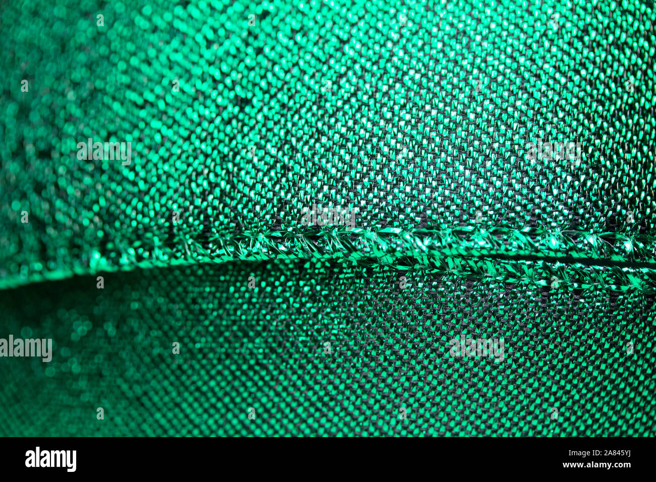 Abstract texture background of macro photographed shimmering green holiday fabric ribbon Stock Photo