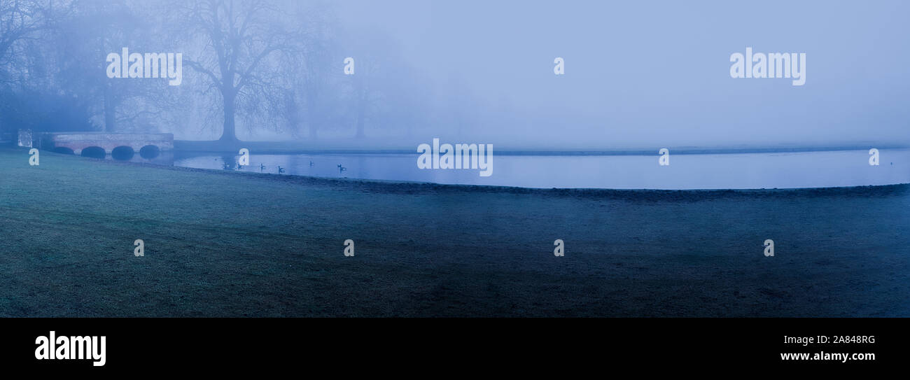 Panoramic view of a foggy lake and bridge Stock Photo - Alamy
