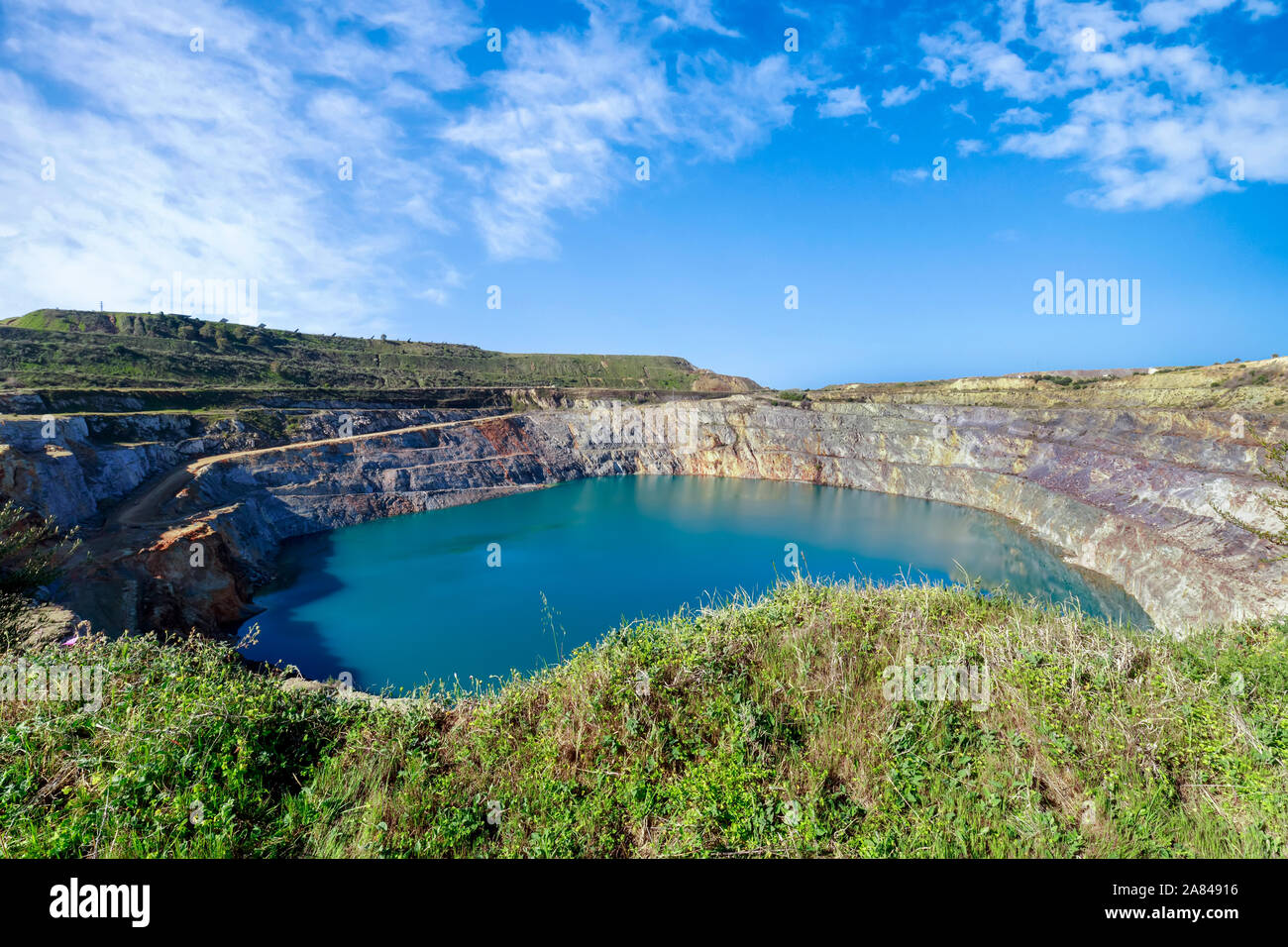 Amazing view of Open Pit Mining on blue sky. Stock Photo