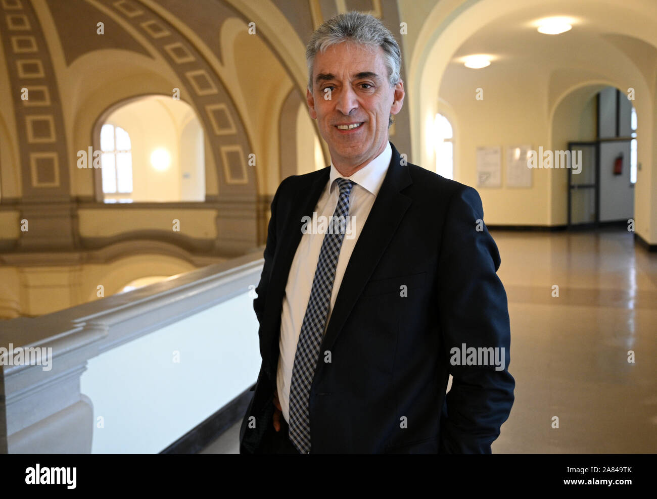 Cologne, Germany. 06th Nov, 2019. Frank Appel, CEO of Deutsche Post AG, stands before a courtroom at the Higher Regional Court in Cologne. Appel has been invited as a witness to a trial concerning the takeover of Postbank by Deutsche Bank. Credit: Henning Kaiser/dpa/Alamy Live News Stock Photo