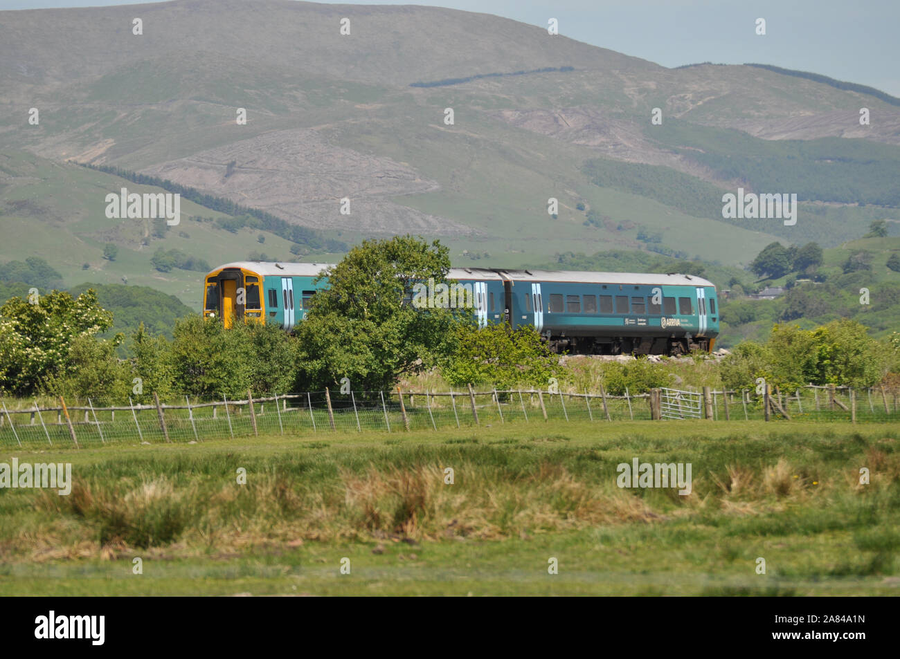 The now defunct Arriva Trains Wales traveling through the Welsh countryside by Borth Wales UK Stock Photo