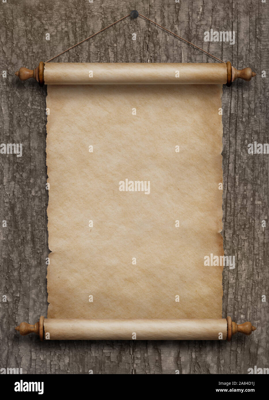 old paper scroll hanging on wood wall Stock Photo
