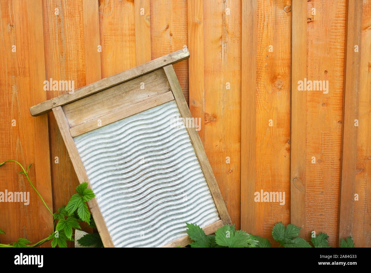 Retro wood and metal washboard used to wash clothes on wooden