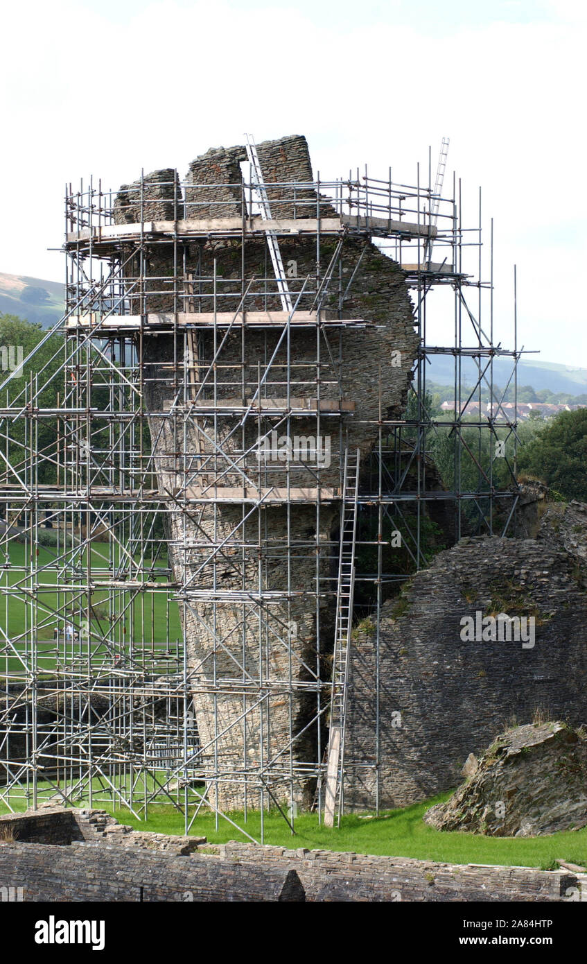The medieval Caerphilly Castle, Mid Glamorgan, South Wales, the second largest castle in Britain. The leaning tower shrouded in scaffolding.10/8/04 Stock Photo