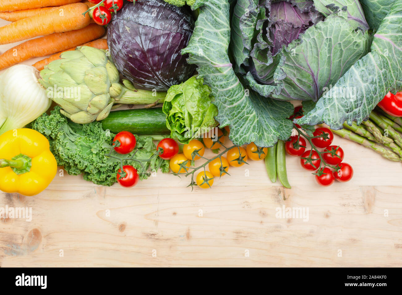 Top view of vegetables on wooden table, carrots velery tomatoes cabbage broccoli, copy space, selective focus Stock Photo