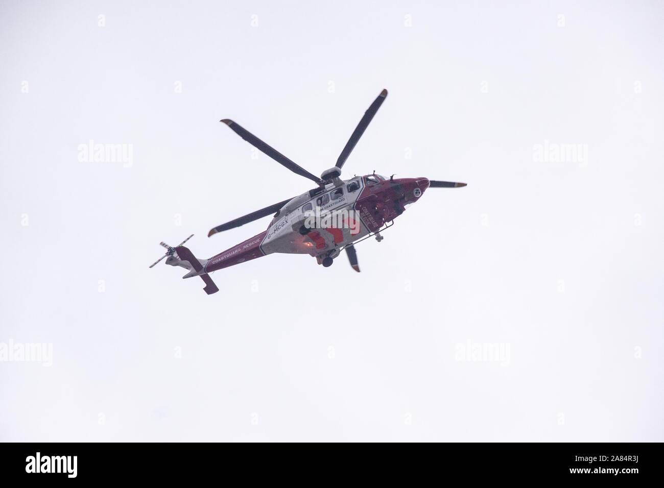Sidmouth, Devon, 6th Nov 2019 The Coastguard helicopter attends an incident where a car was reportedly driven over a cliff at a remote spot to the west of the seaside town. Photo Central/Alamy Live News Stock Photo