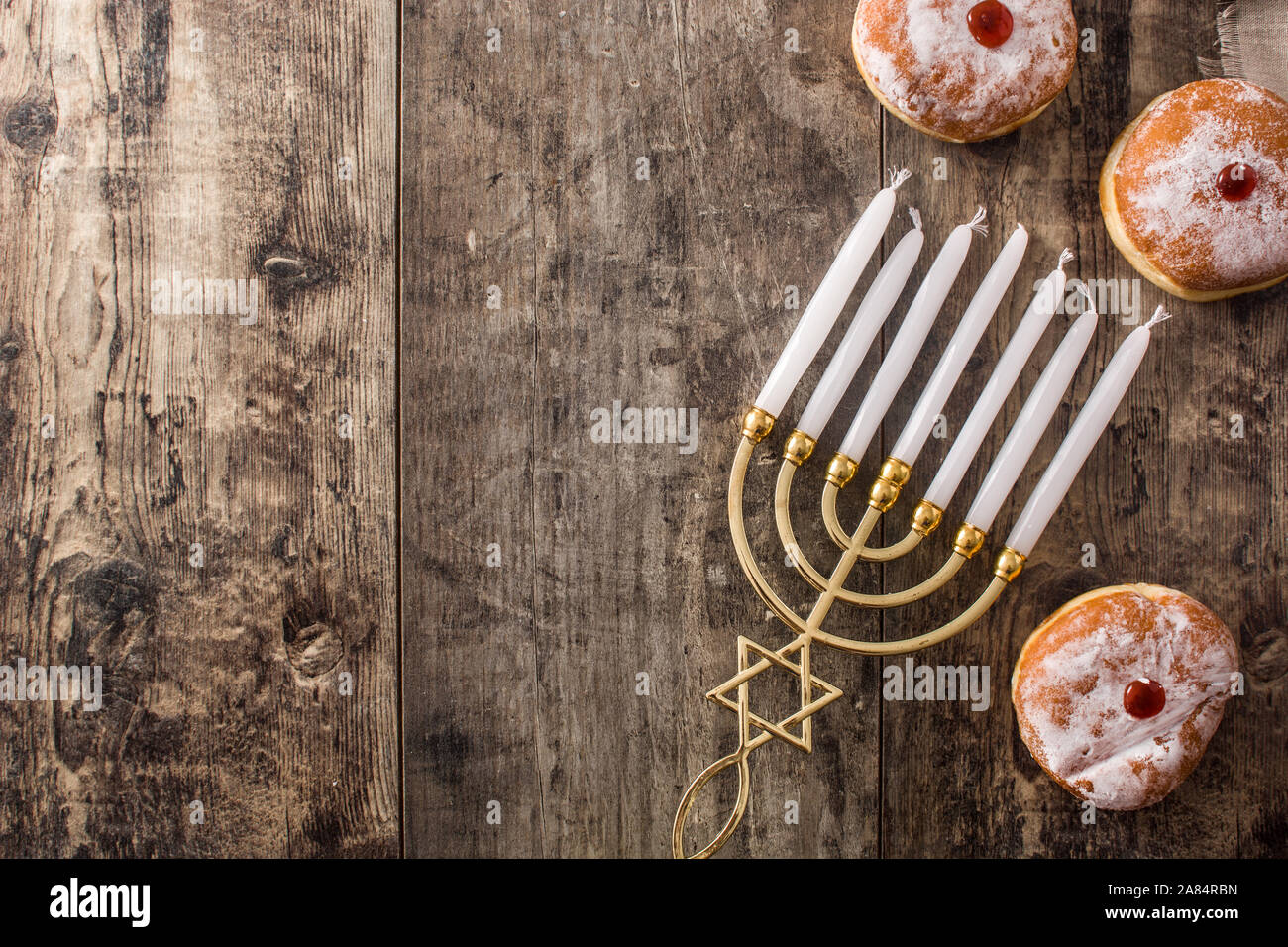Jewish Hanukkah menorah and sufganiyot donuts on wooden table. Top view. Copy space Stock Photo