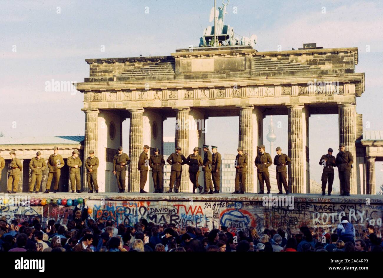 GDR border forces stand on top of the Berlin Wall, Germany, 11 November 1989. The Wall was opened in the night 09/10 November. (dpa / IPA / Fotogramma, Berlin - 2014-10-17) ps the photo is usable in respect of the context in which it was taken, and without defamatory intent of the decorum of the people represented Editorial Usage Only Stock Photo