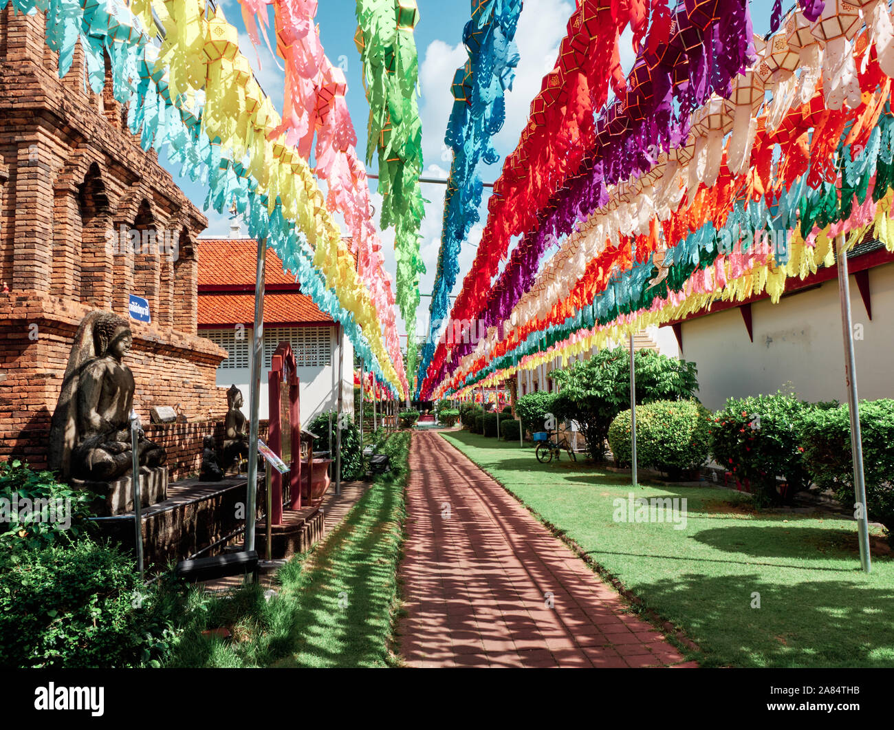Colourful lanterns lead the way at Wat Hariphunchai in Lamphun, Thailand. Stock Photo