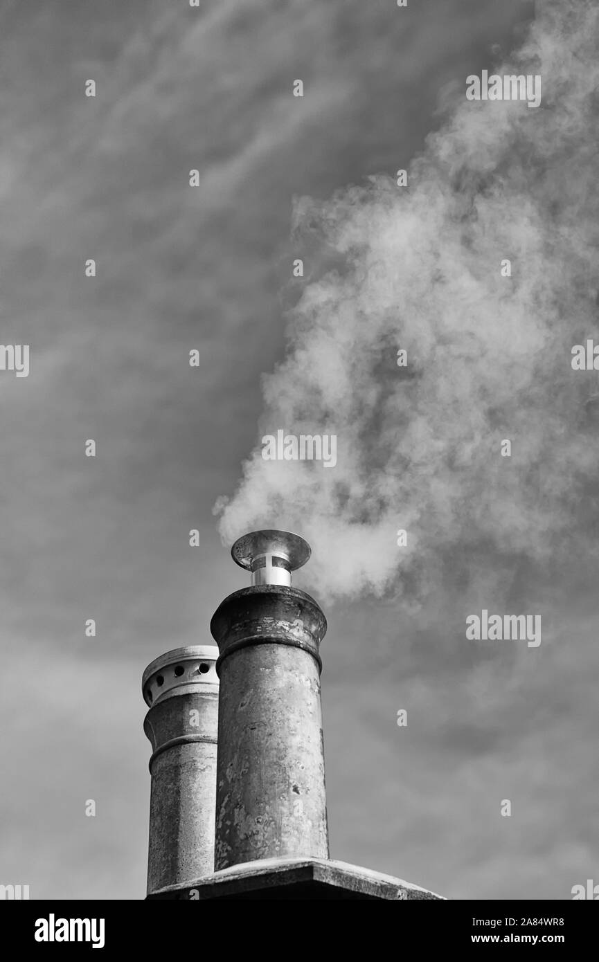 Steam / Smoke Emitting from Domestic Chimney Stack Stock Photo