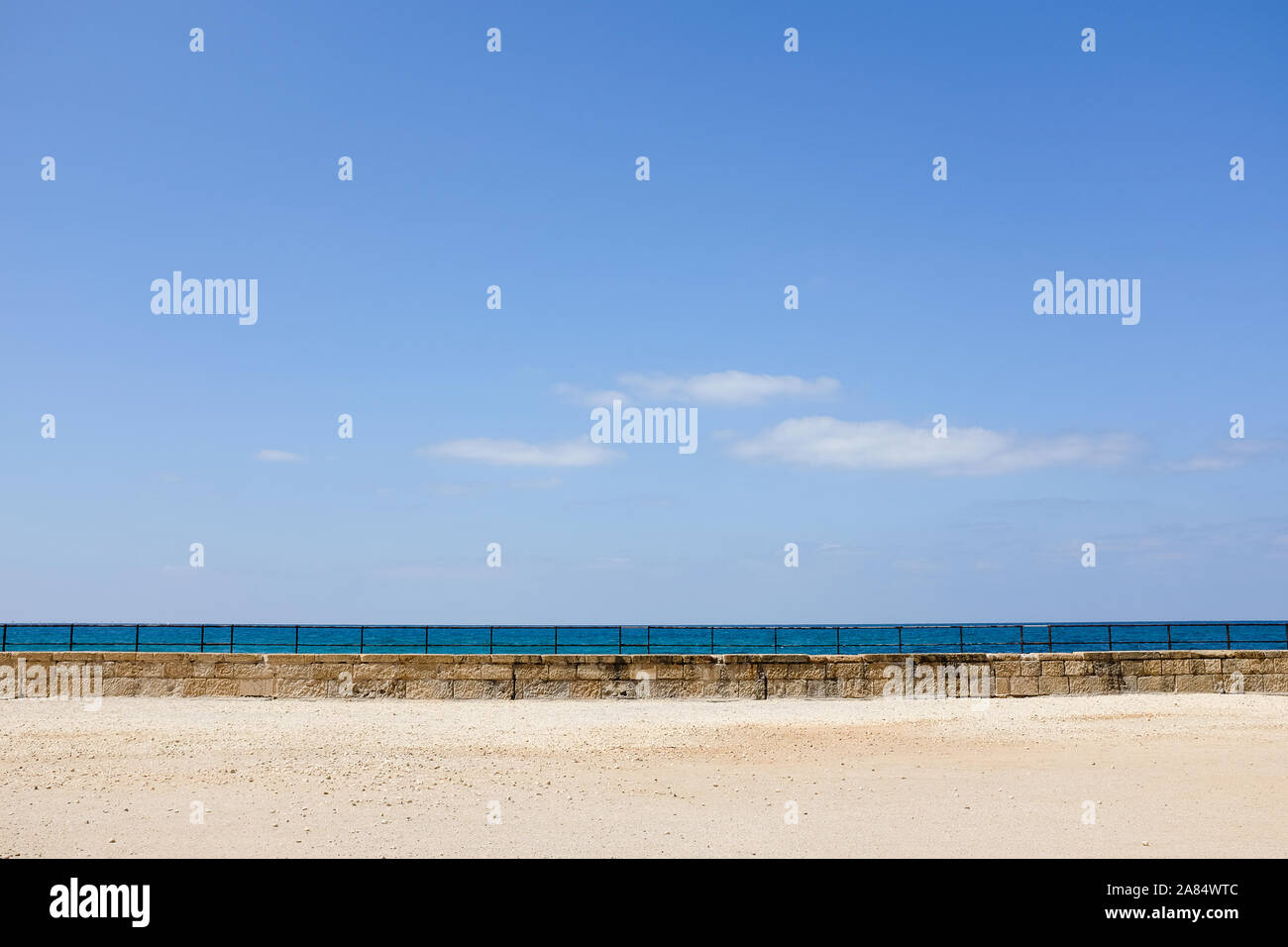 Wide view of harbour wall with blue sky Stock Photo
