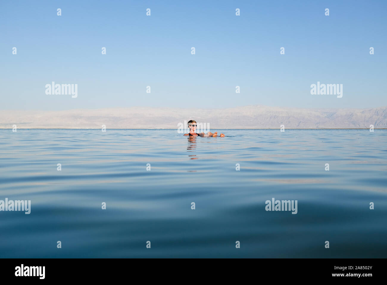 Single tourist floating in the Dead Sea Stock Photo