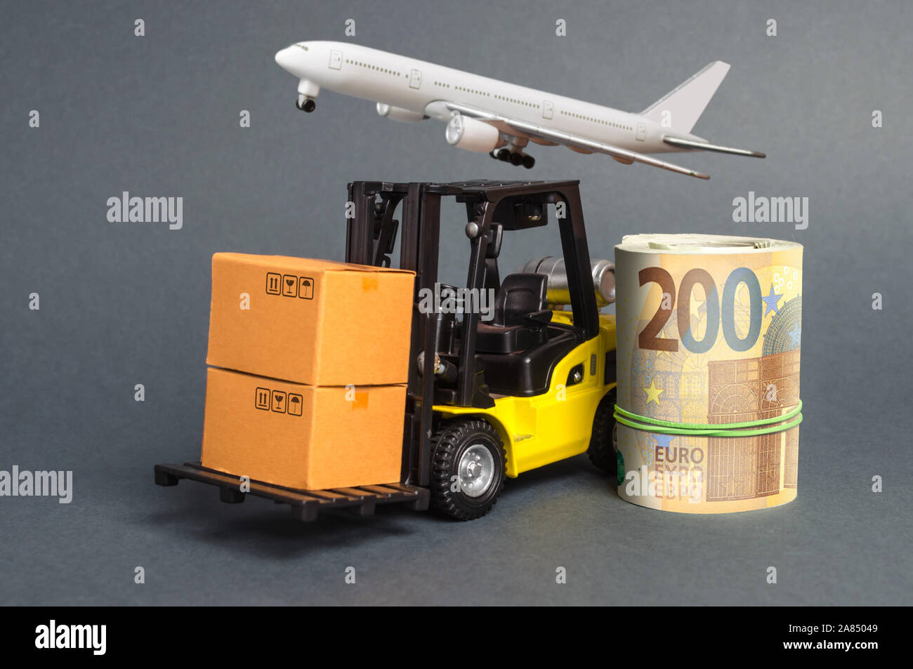 A forklift truck carries cardboard boxes and Euros roll. Transport company. Performance efficient. Trade and production of products and goods, balance Stock Photo