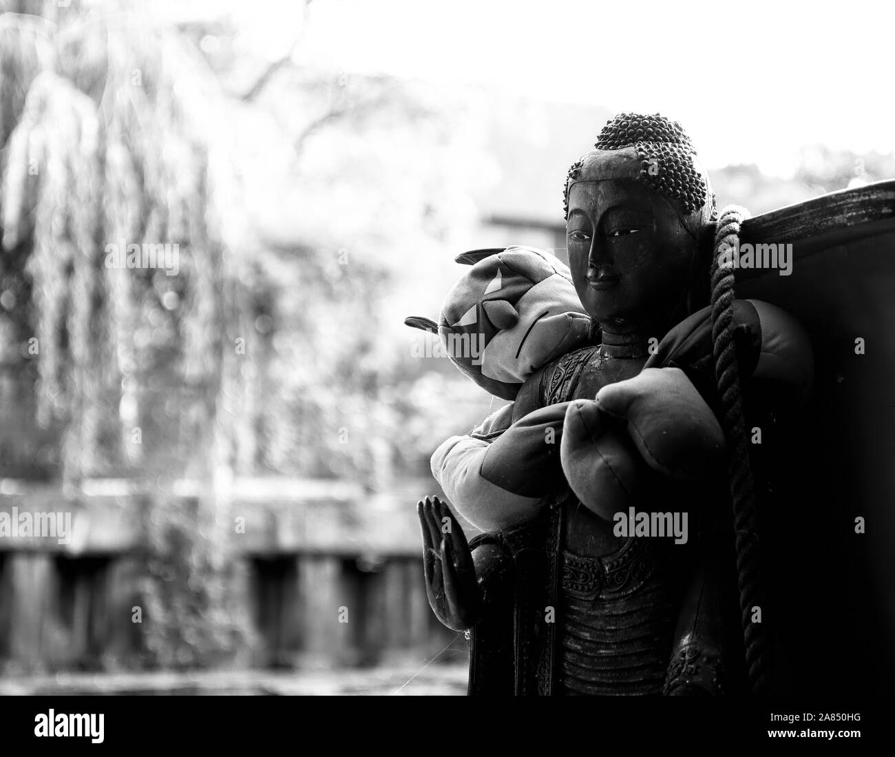 Batman hugs an Indian statue Stock Photo