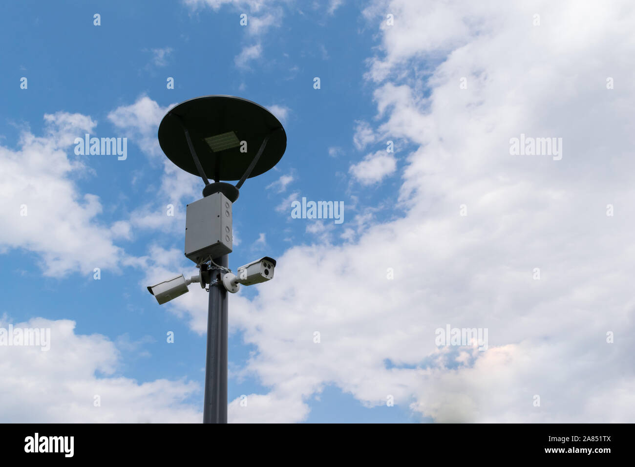 security surveillance cameras mounted on street light pole with copy
