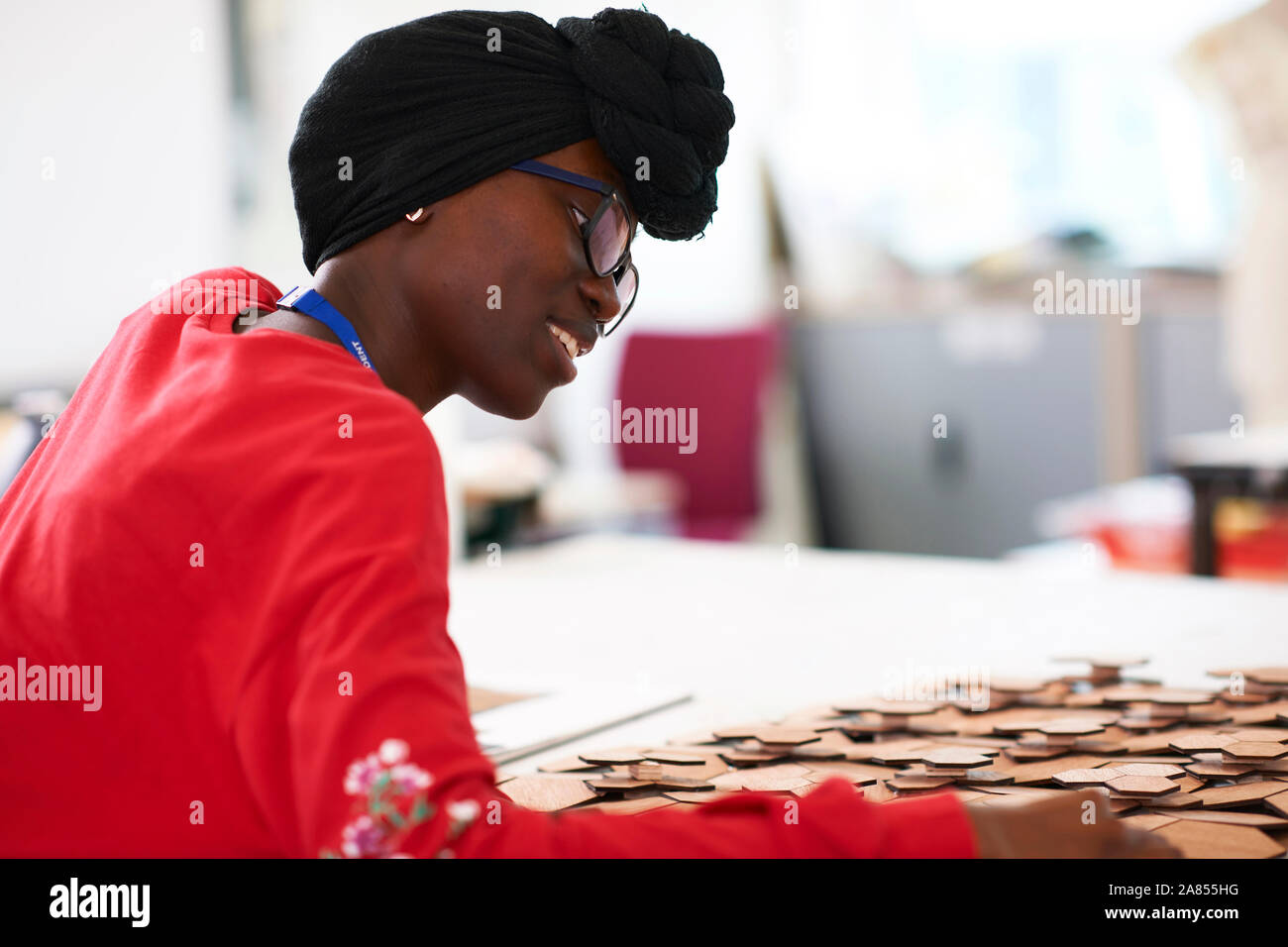 Young female artist wearing dhuku in art studio Stock Photo