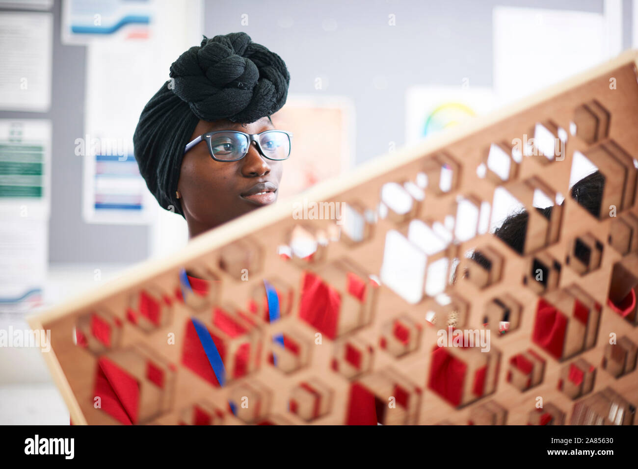 Female artist in dhuku headscarf working in art studio Stock Photo