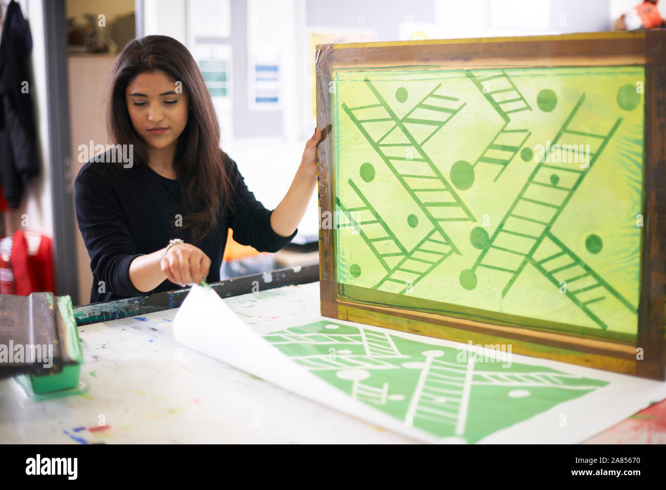 Female artist screen printing in studio Stock Photo