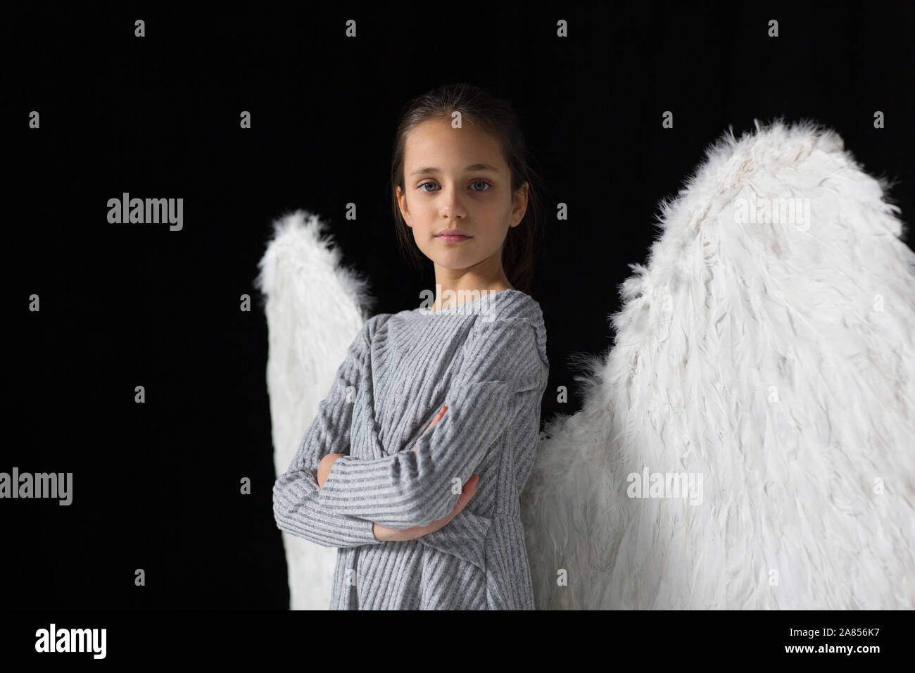Portrait confident, brave girl wearing angel wings Stock Photo