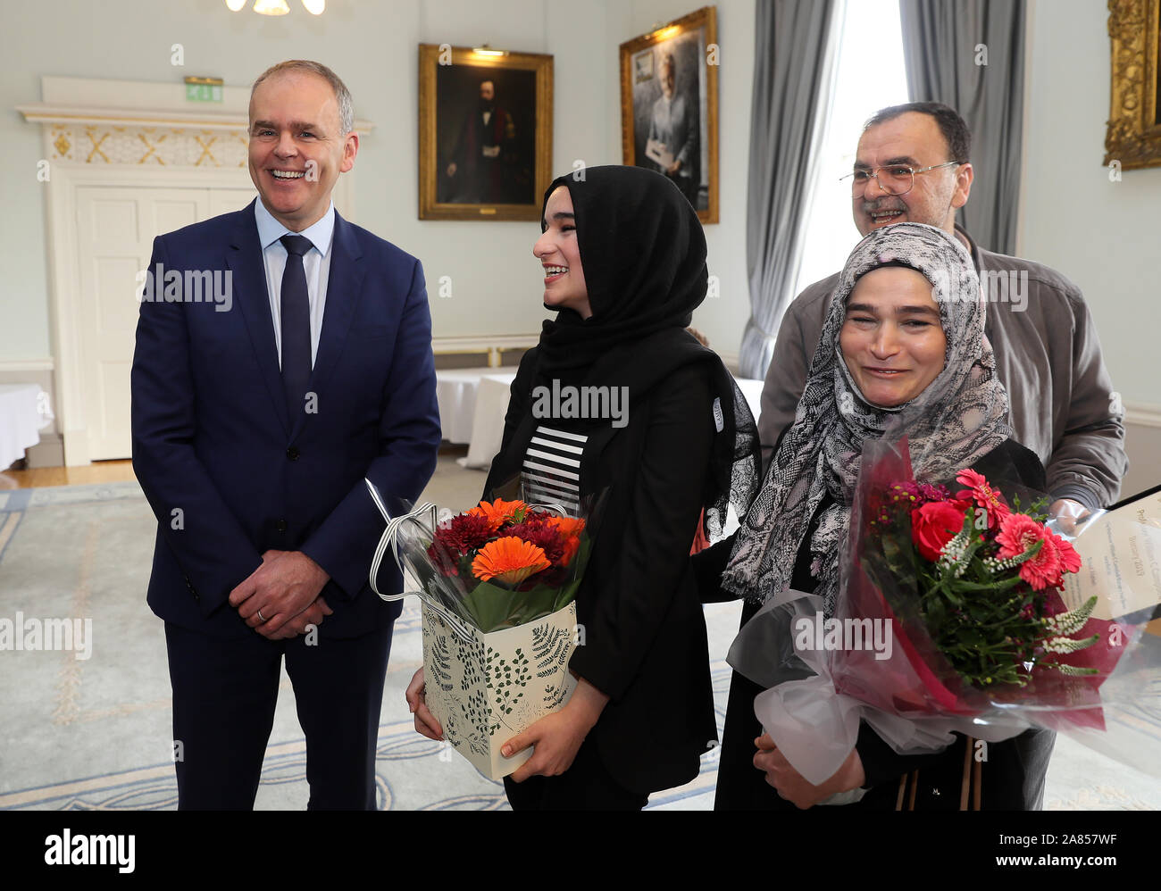 Minister for Education Joe McHugh (left) speaking with RCSI medical student Suaad Alshleh (second left), her mother We Sam Jouma and father Issam Alshleh at the Royal College of Surgeons Ireland in Dublin. Suaad was presented with the inaugral Professor William C Campbell Bursary which recognises the work of the Donegal Nobel Prize winner. Stock Photo