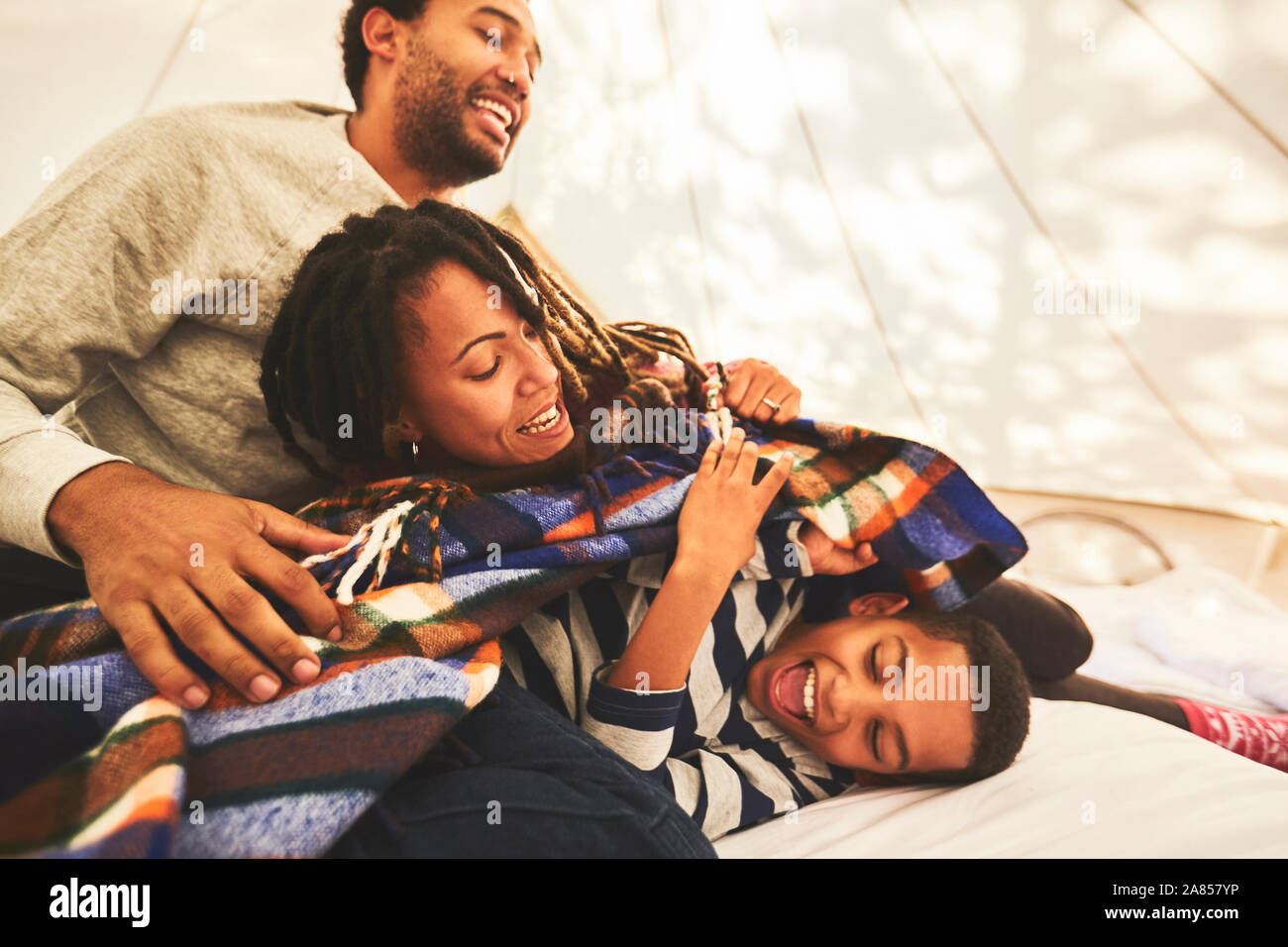 Playful family in camping yurt Stock Photo