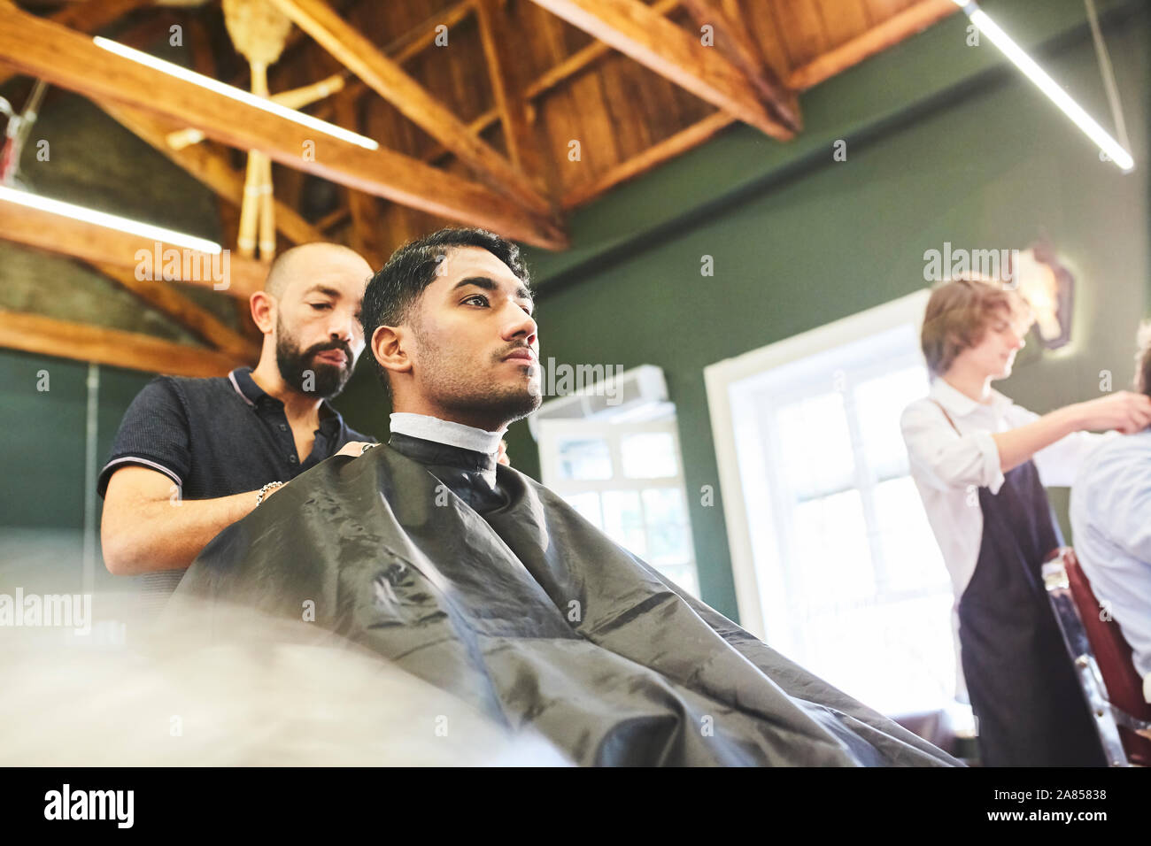 Male customer getting a haircut in barbershop Stock Photo