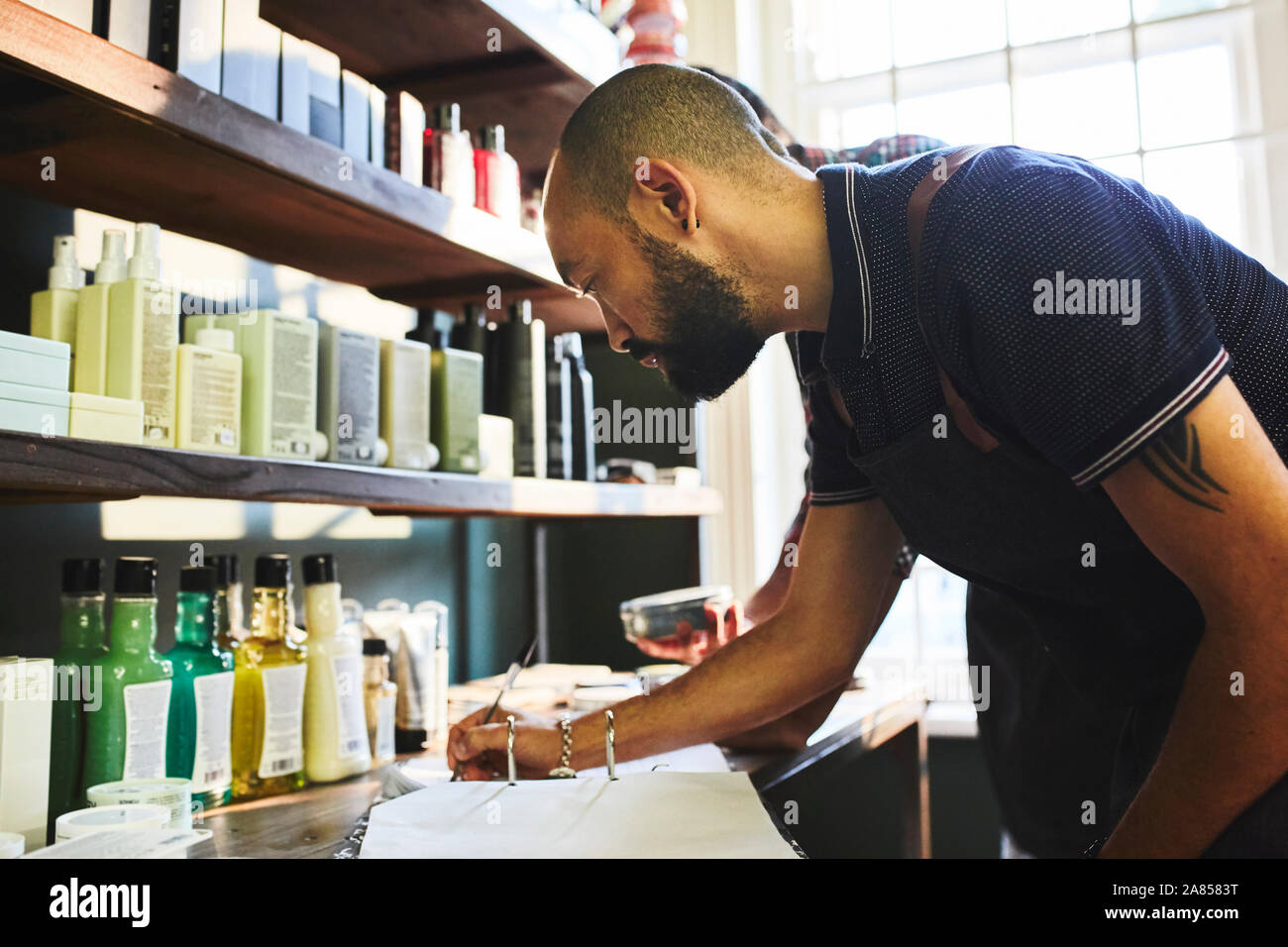 Male barbershop owner doing paperwork Stock Photo