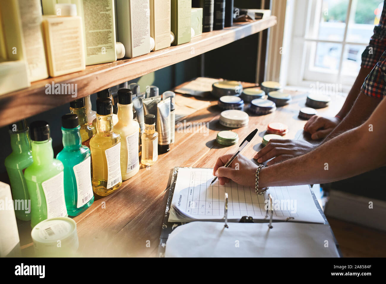 Male barbershop owner checking product inventory Stock Photo