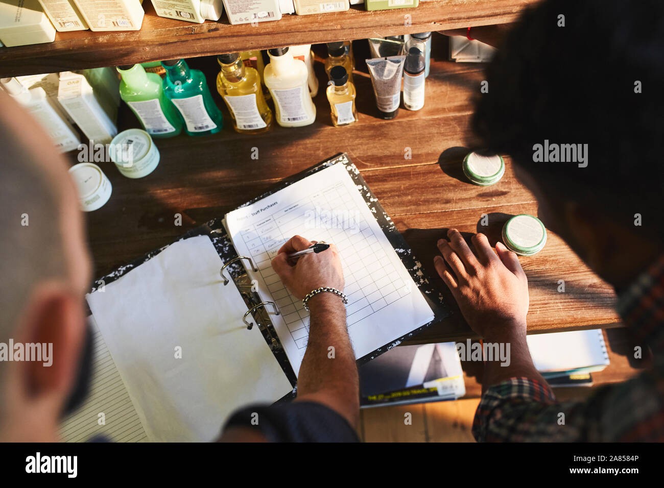 Male barbershop owner checking product inventory Stock Photo