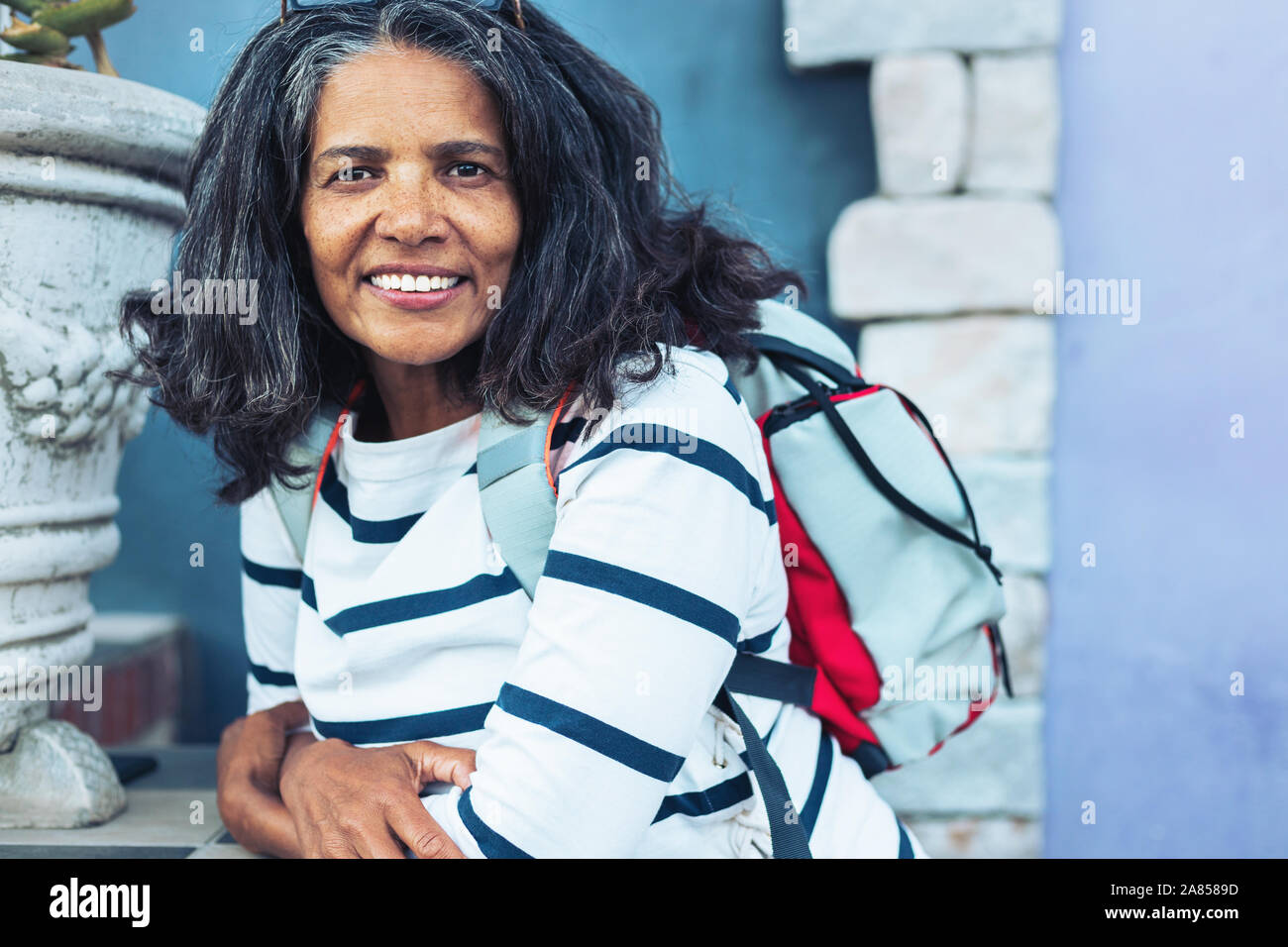 Portrait smiling, confident woman with backpack Stock Photo