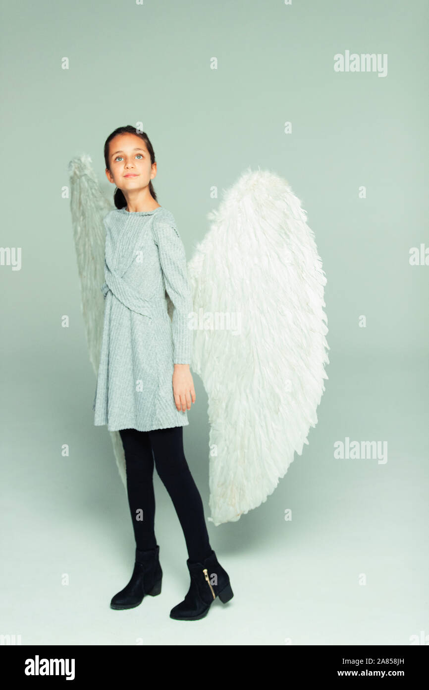 Portrait hopeful, ambitious girl wearing angel wings Stock Photo