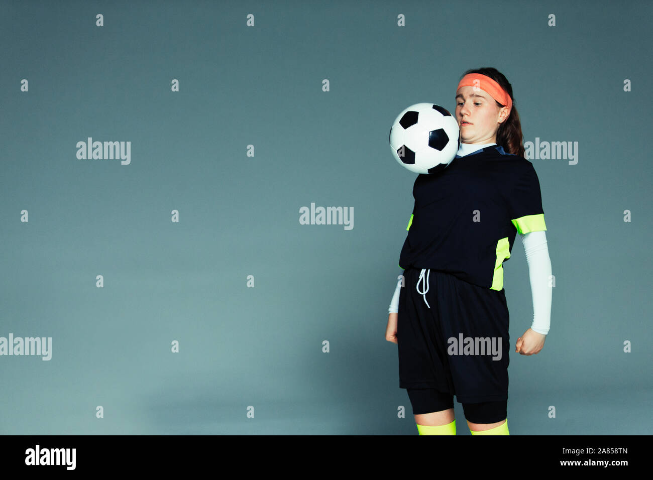 Teenage girl soccer player balancing ball on chest Stock Photo Alamy
