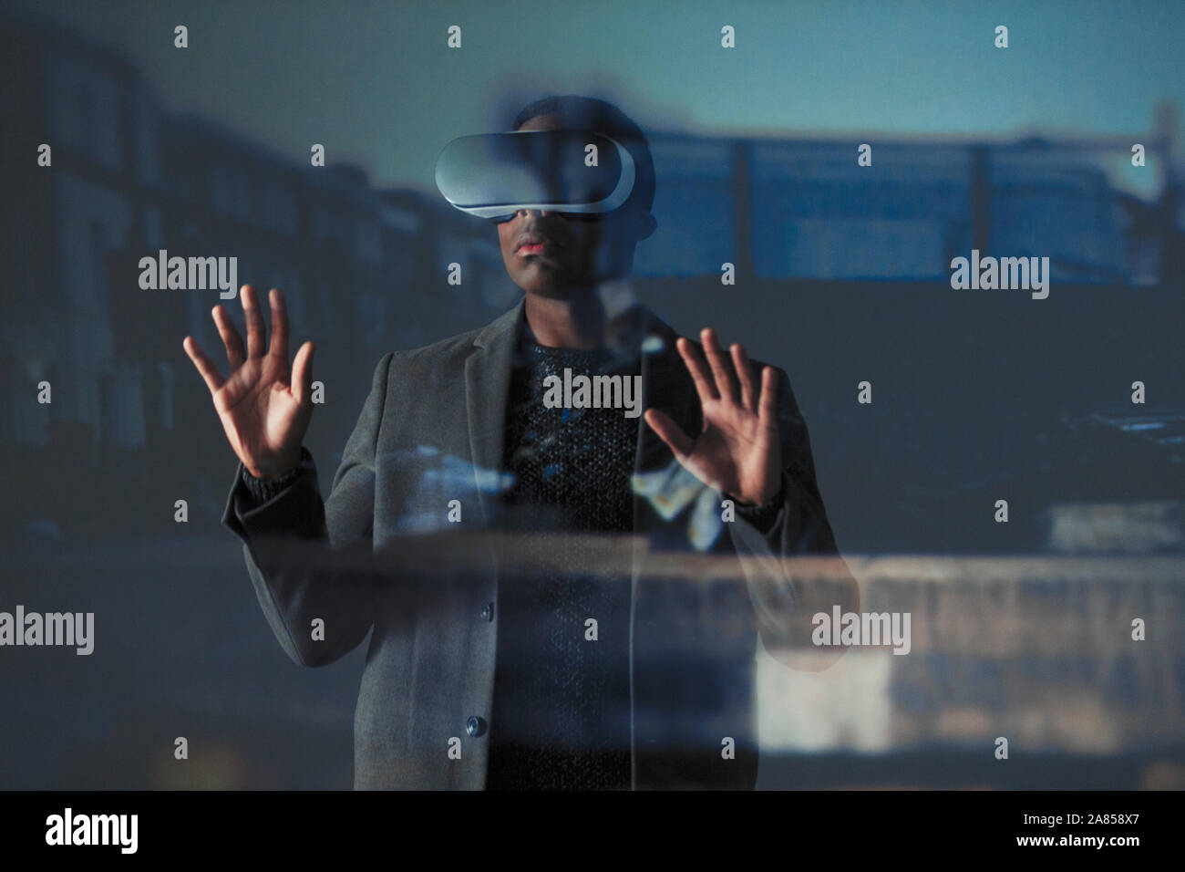 Double exposure businessman using virtual reality simulator glasses Stock Photo