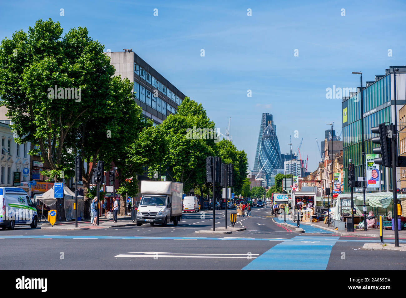 Looking down the Mile End Road London towards the buildings of the city Stock Photo