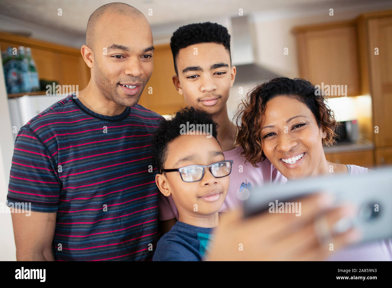 Family taking selfie in kitchen Stock Photo