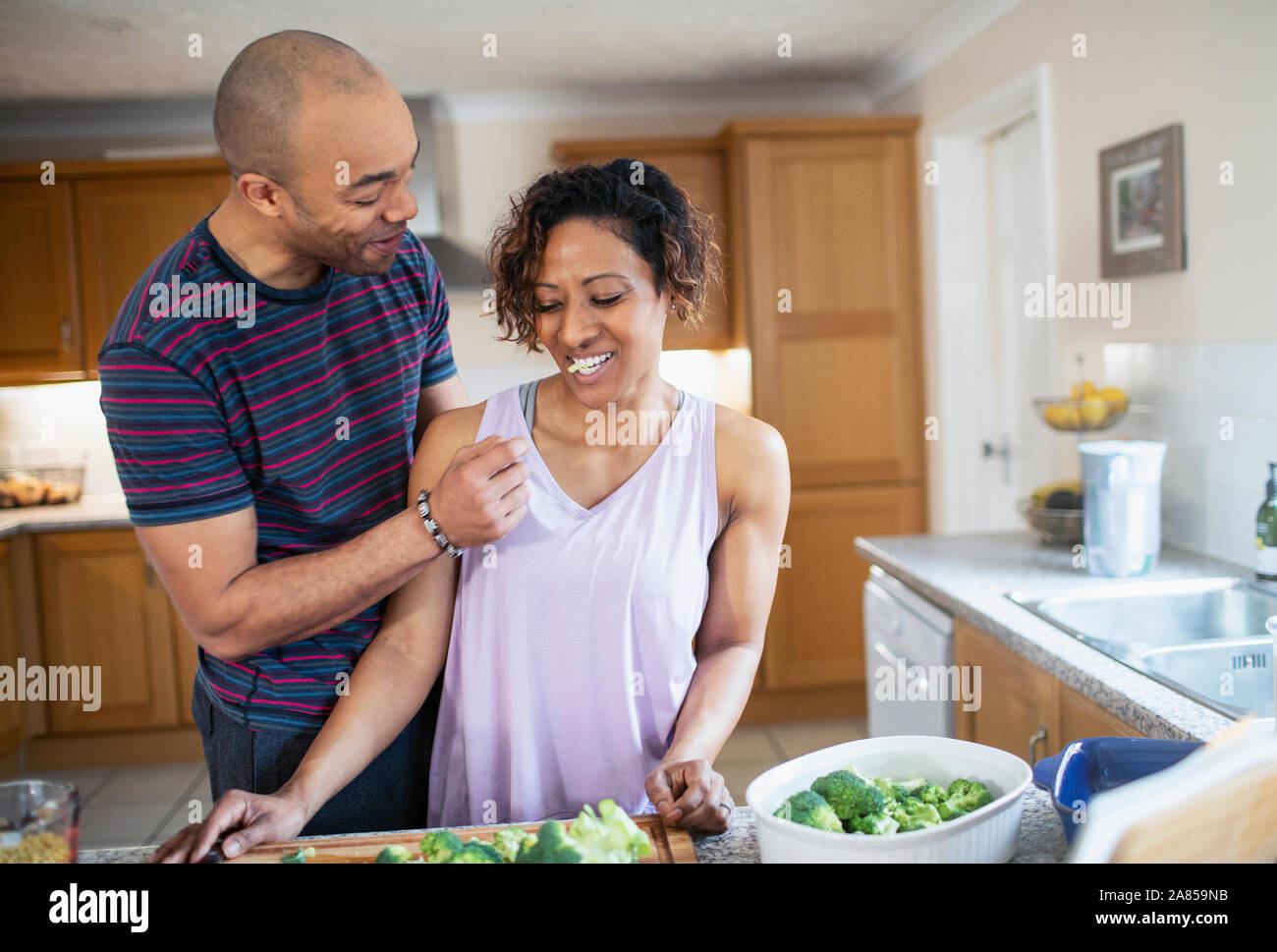 Happy couple cooking in kitchen Stock Photo