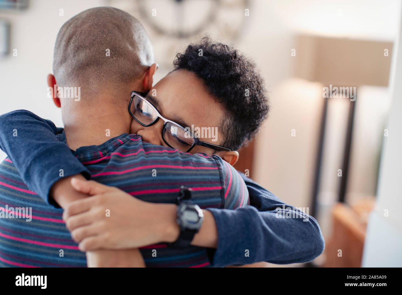 Affectionate son hugging father Stock Photo