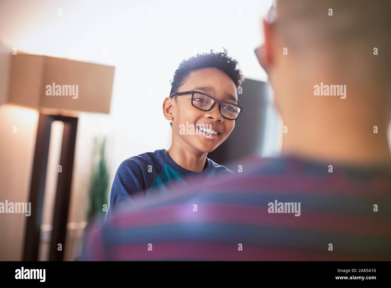 Smiling son talking with father Stock Photo