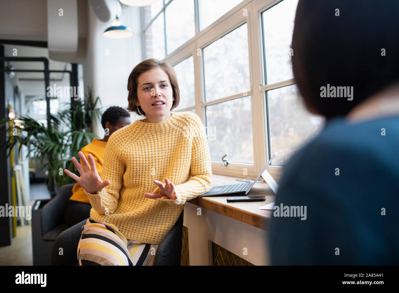 Businesswomen talking in office Stock Photo