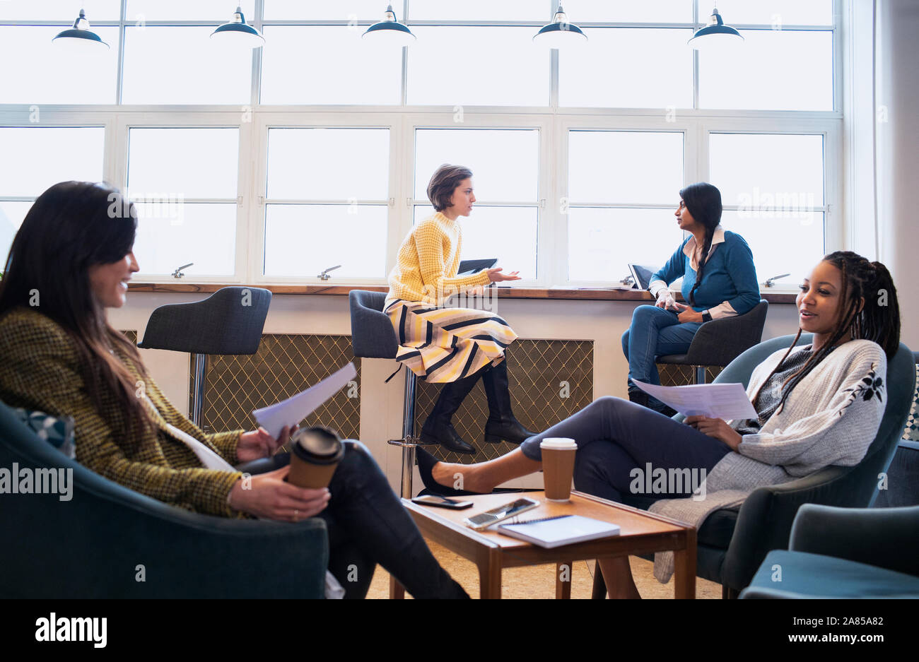 Businesswomen talking in office Stock Photo