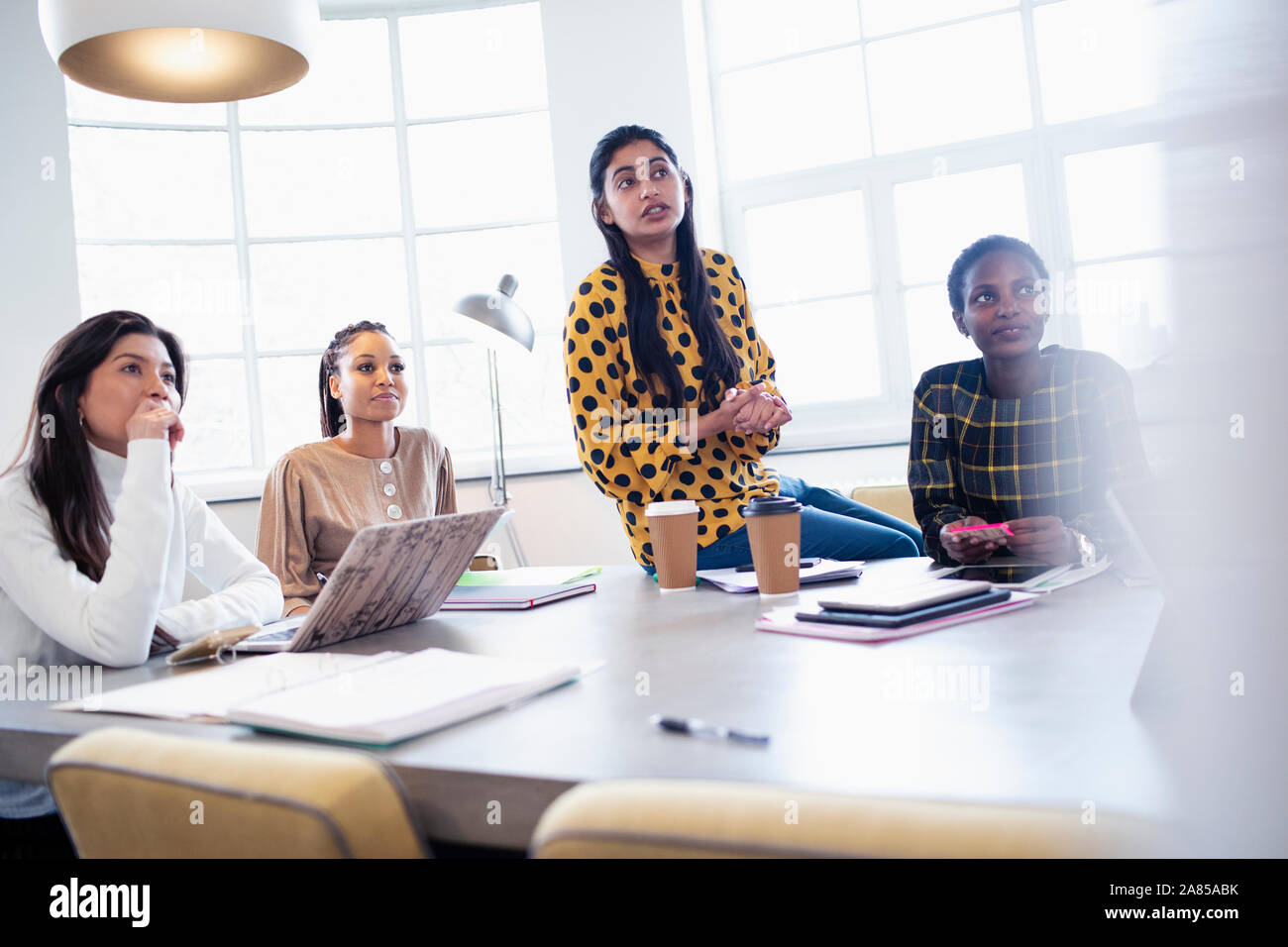 Attentive businesswomen listening in conference room meeting Stock Photo