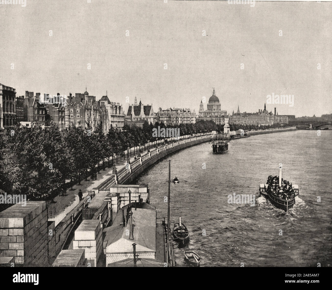 From 'The Descriptive Album of London' by George H Birch 1896 - Extract text : ' THE VICTORIA EMBANKMENT extends along the left bank Of the Thames, from Westminster Bridge to Blackfriars, a distance of nearly miles. It was constructed in 1864-70, under the superintendence of Sir Joseph Bazalagette, at a cost of about It consists of a carriage way 64 ft. wide, and two foot pavements Of 16 and 20 ft. in breadth respectively, the whole of which surface was, until the construction of the Embankment, covered by the tide twice a day. On the river-side it is protected by a granite wall and balustrade Stock Photo