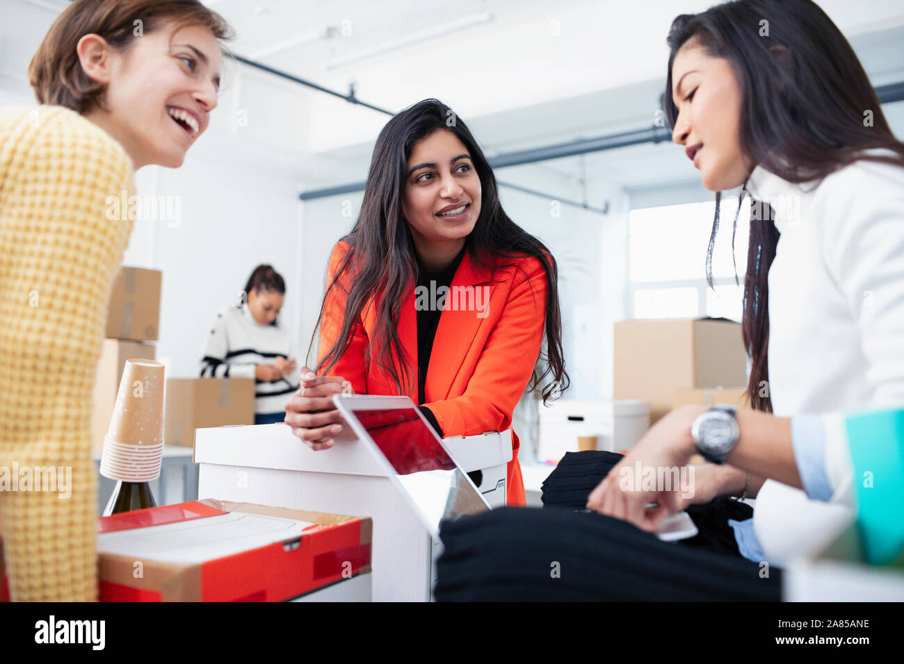 Businesswomen talking in new office Stock Photo