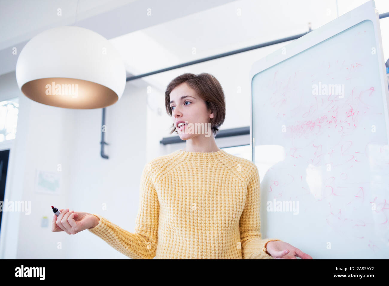 Businesswoman at whiteboard leading meeting Stock Photo