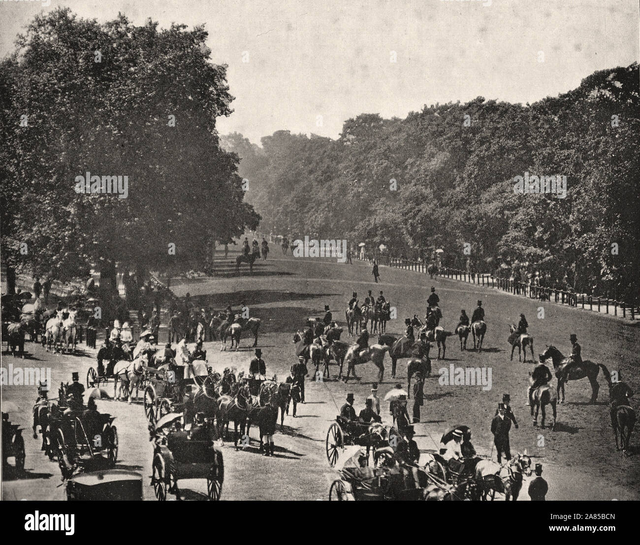 From 'The Descriptive Album of London' by George H Birch 1896 - Extract text : ' ROTTEN ROW.—It is by this name 'that is known the tract, stretching from Hyde Park Corner to Queen's Gate, which is kept apart for the sole use of equestrians. with Rotten Row is The Drive,' which extends along the same distance. On a fine day this is one of the most characteristic sights of London. In the season are thronged from 11 to 1, and again fronl 5 to 7, with fashionably dressed people riding, driving, walking or seated on chairs provided at the Of On Sunday mornings, after Church, crowds of Ladies and Ge Stock Photo