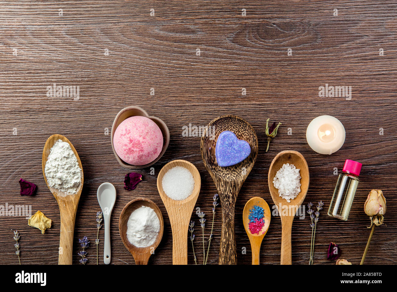 Making bath bombs at home concept. All the ingredients on table on wood spoons. Stock Photo