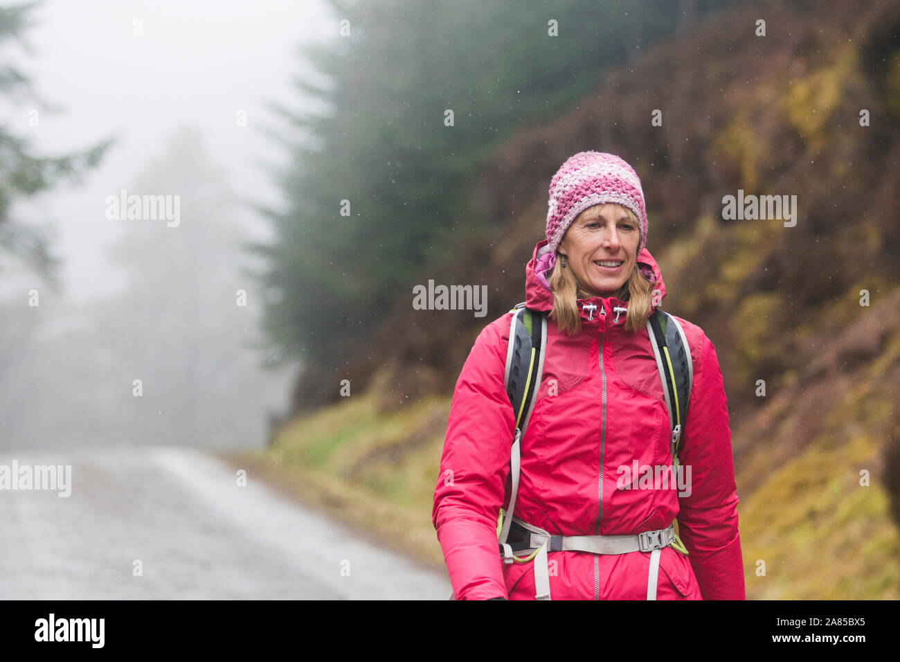 Mature woman hiking on trail hi-res stock photography and images - Alamy