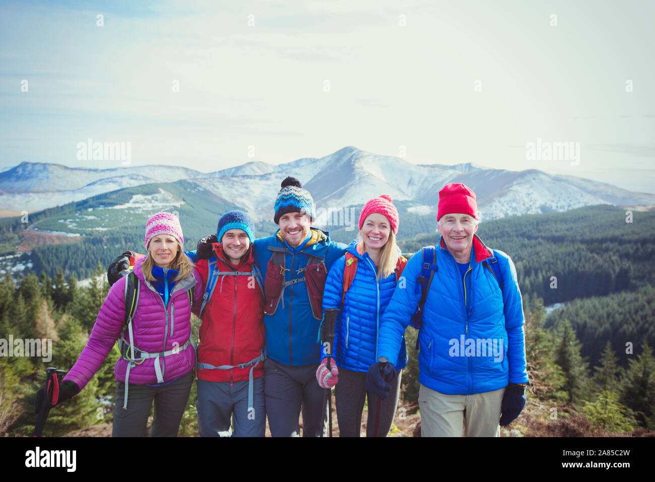 Portrait happy family hiking with mountains in background Stock Photo